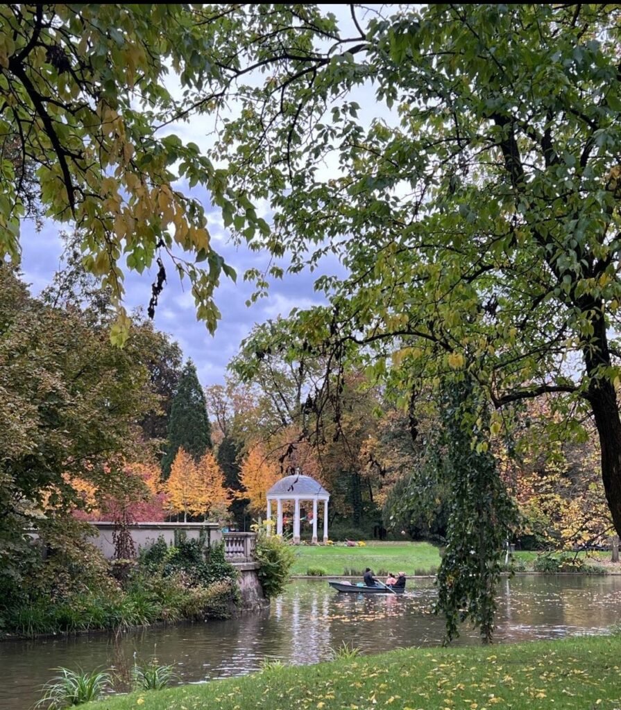 a boat in a body of water with a gazebo and trees